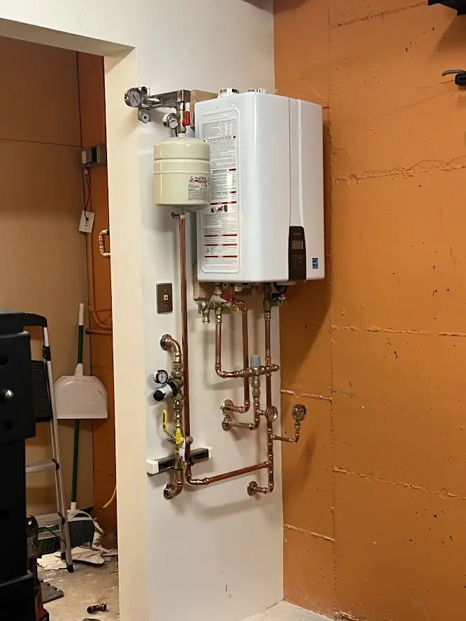 Plumbing technician inspecting water heater connections in Marietta